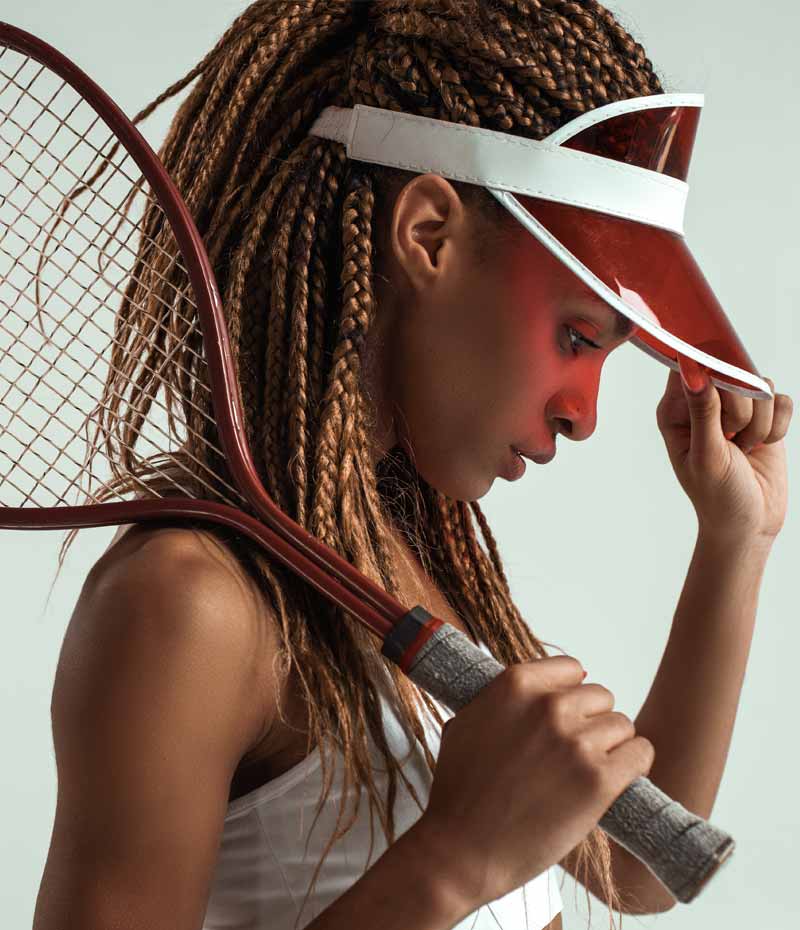 Sportliche junge afrikanische Frau mit Tennisschläger